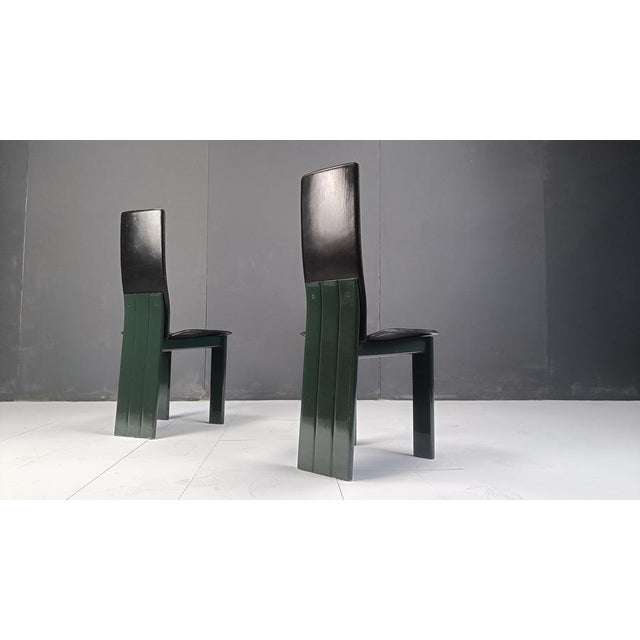 Postmodern black leather dining chairs with Green lacquer bases. Unique set we've never seen before. Very good quality,...