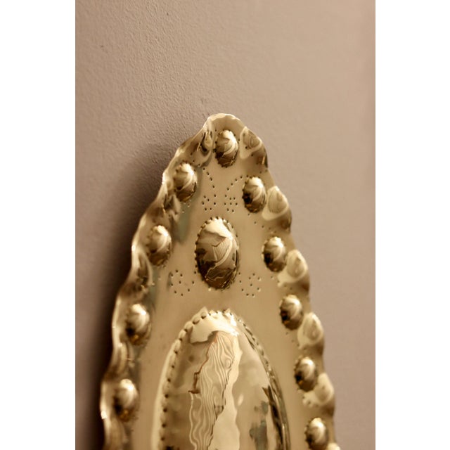 Made in Sweden A breath-taking mid-century duo of exquisite Swedish brass wall sconces, showcasing captivating hammered...