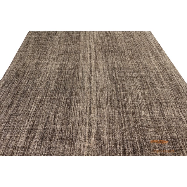 Handmade in flat woven wool originating circa 1950-1960, this vintage Kilim rug is a transitional piece that is notably...