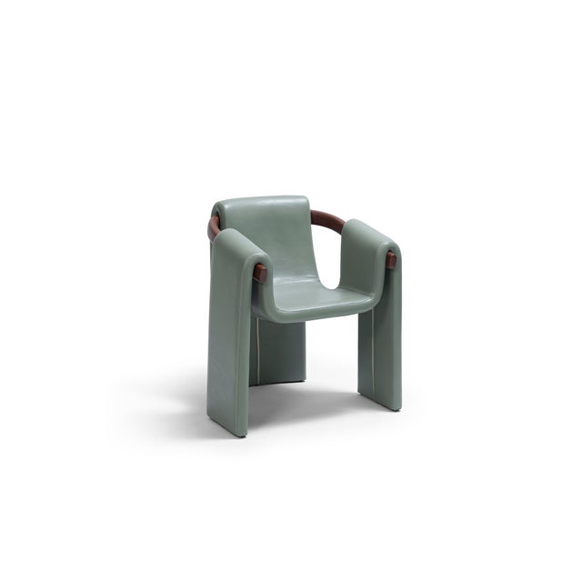 The Palo Dining Chair redefines contemporary craftsmanship with its sculptural silhouette and refined materiality. Fully...
