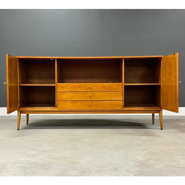 A mid century modern solid maple sideboard credenza designed by Paul McCobb for Winchendon’s Planner Group. Brass knobs...