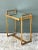 Crafted with clean geometric lines, this vintage mid-century side table features a slender brass frame paired with an...