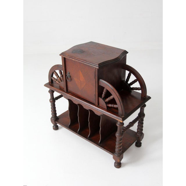 An exceptional early 20th century Jacobean Revival humidor stand featuring a copper-lined tobacco cabinet, beautifully...
