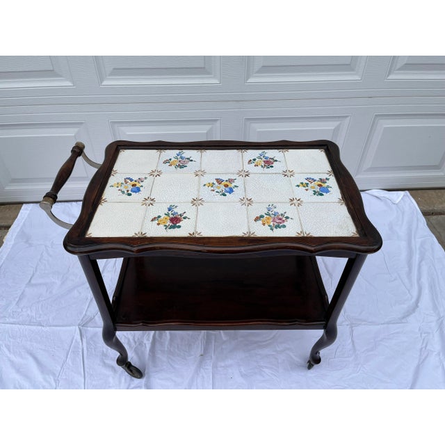 English style Wood and Tile Two Shelf Rolling Bar Cart/Table. Featuring sculpted top , brass and wood handle and...