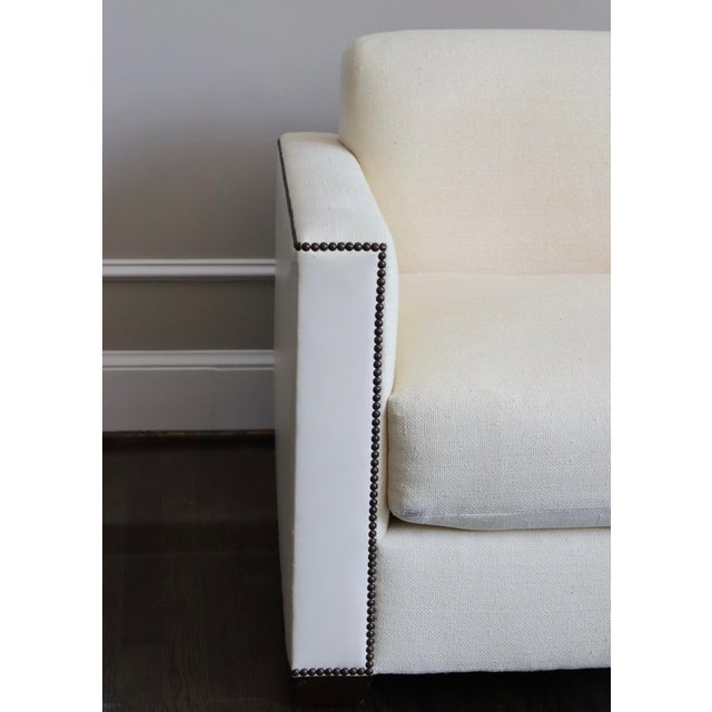 Ivory Baker Sofa featuring ivory leather and linen silk upholstery with Nailhead trim. Great condition! There are two...