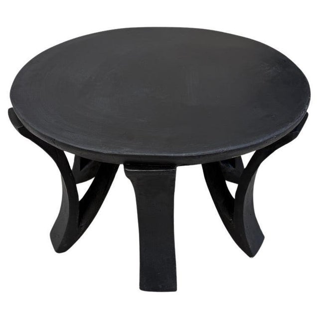 An unusually large diameter on this rustic side table or coffee table. Hand carved from a single block of wood. We have...