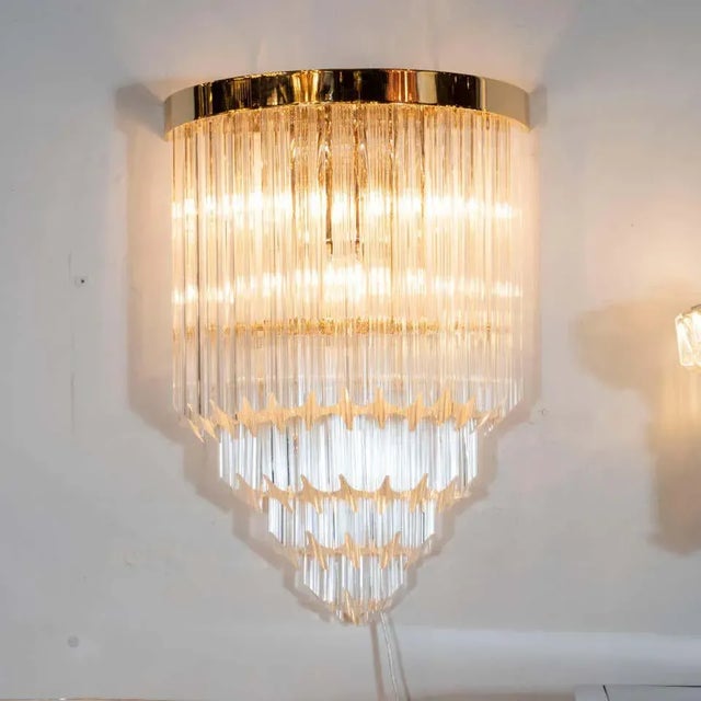 This elegant and dramatic pair of quadretti sconces were realized in Murano, Italy- the island off the coast of Venice...