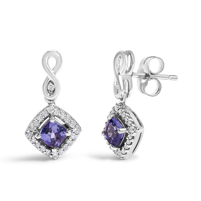 Drape your ears in the celestial sparkle of our exquisite earrings, each featuring a cushion-cut, heat-treated tanzanite...