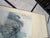 Elegant vintage Chinese hanging scroll depicting a dramatic traditional mountain landscape rendered in atmospheric blue-...