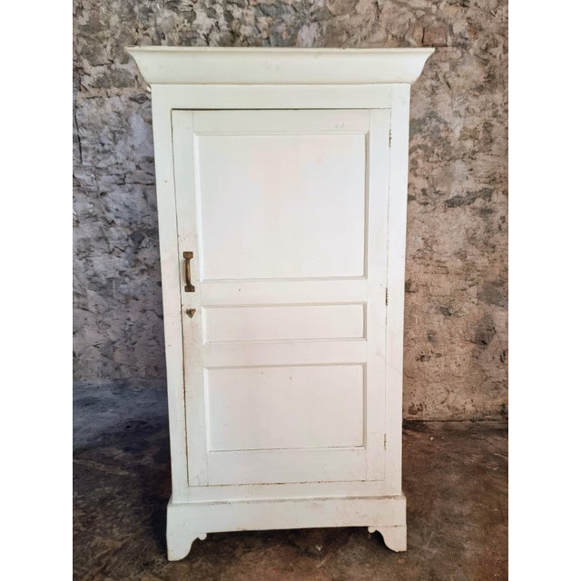 This antique French cabinet dates from the early 20th century and is crafted from solid pine. The piece features a simple...