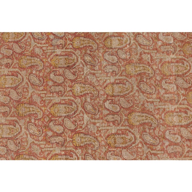 An early 20th century Amritsar antique two-toned carpet, the rust red field with an overall condensed design in ochre of...