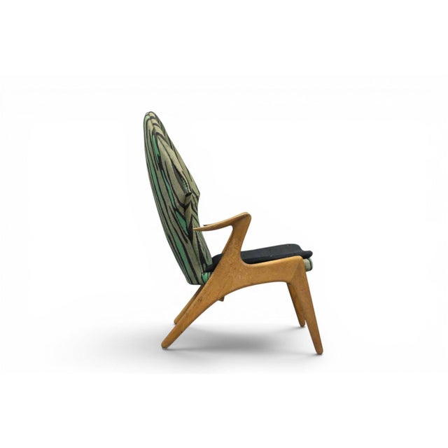 This striking highback lounge chair brings the quiet confidence of Danish modern design into any room, with a sculpted...