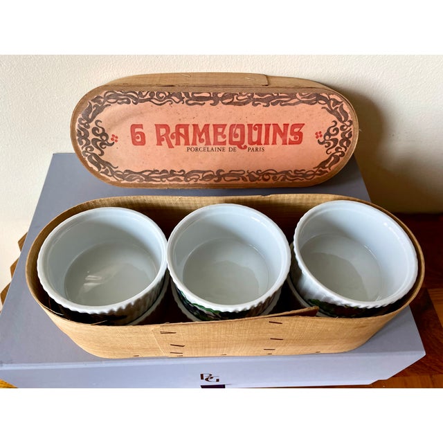 Six beautiful porcelain French ramequins nestled in the original oval wooden box with brand stamp and Havre’s Paris tag....