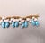 1960s Vintage Napier Book Piece Goldtone Blue & Turquoise Art Glass Charm Bracelet, 1967 For Sale - Image 5 of 15