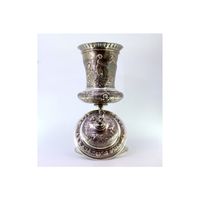 Silver Urn with Engravings and Reliefs, in Very Good conditions. Designed from 2000 This piece has an attribution mark, I...