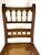 A finely detailed Eastlake-style chair in warm walnut, featuring a hand-caned seat and an intricately carved back with...