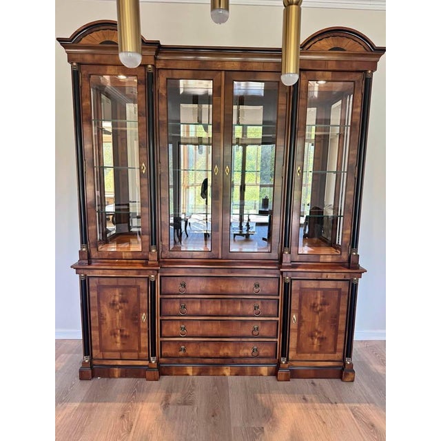 This is a fabulous neoclassical style china cabinet designed by Raymond Sabota for high-end American furniture maker...