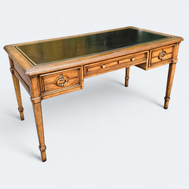 Featured is a Vintage Hollywood Regency Sligh Lowry Leather Top Writing Desk in the vein of a traditional bureau/partner’s...