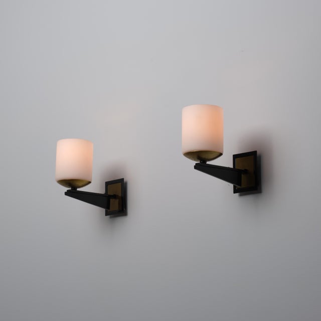 This set of Italian wall sconces from the 1950s exemplifies mid-century modern elegance. Each sconce features a robust...