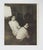 1950's vernacular snapshot photograph of two women sitting and looking back. Unframed, has been trimmed.