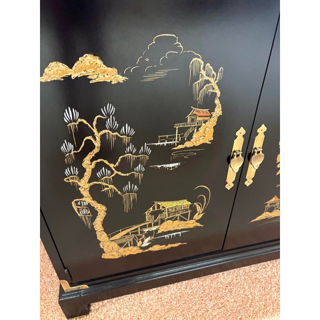 1960s asian campaign style black lacquered/gold painted 2-door chest/console w/ brass corner detail. Excellent condition.