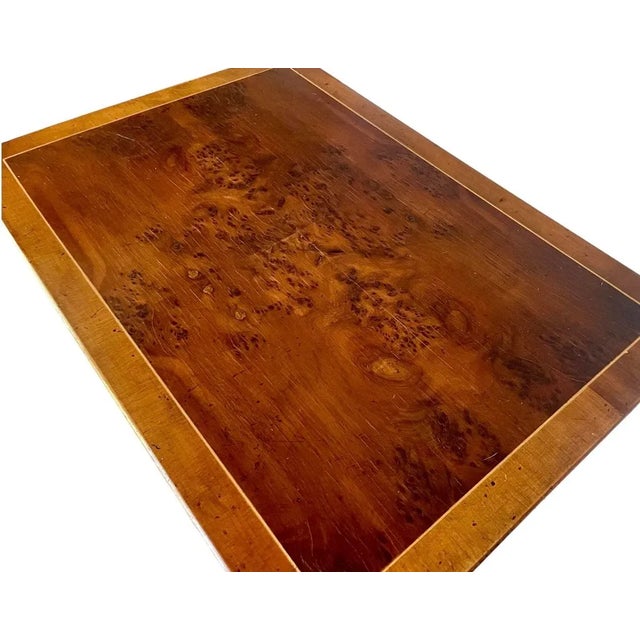 Functional and elegantly stylish, this set of three Regency style nesting tables feature tops of burr and cross-banded yew...