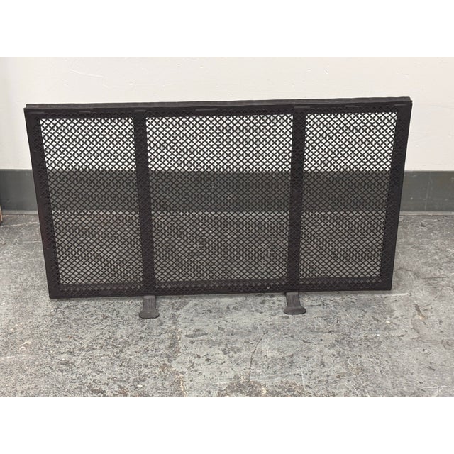 Design Plus Gallery presents a Vintage Quatrefoil Pierced Iron Fireplace Screen. This iron fireplace screen has a...