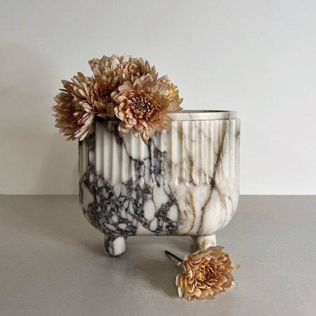 Handcrafted from white marble, the Crenature Vase combines a softly rounded silhouette with fluted detailing and a subtle...