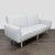 This modern 3-seat sofa features a clean, simple design with soft cream upholstery and a sturdy light wood base. The...