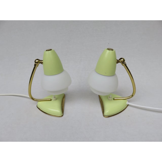 This set of two table lamps was made in Italy in the 1950s. The lampshades are made from matt white cameo glass with a...