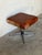 This square ottoman features a striking patchwork top over a minimalist tubular frame. The bold geometric design creates...
