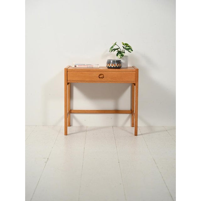 An elegant Scandinavian oak sewing table, designed in the 1960s by Egström & Myrstrand, with clean, measured lines. A...