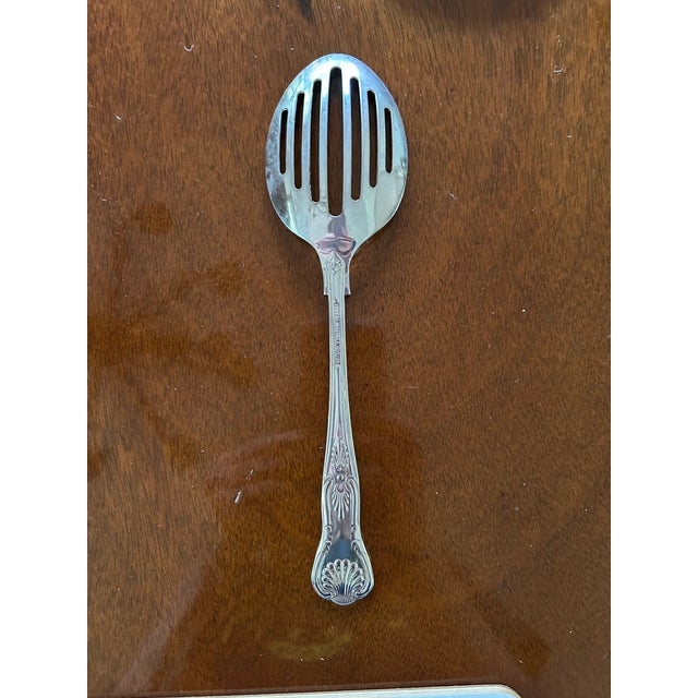 This vintage S.G. England EPNS A1 silver plated slotted serving spoon "Kings Pattern" is a classic and elegant piece of...