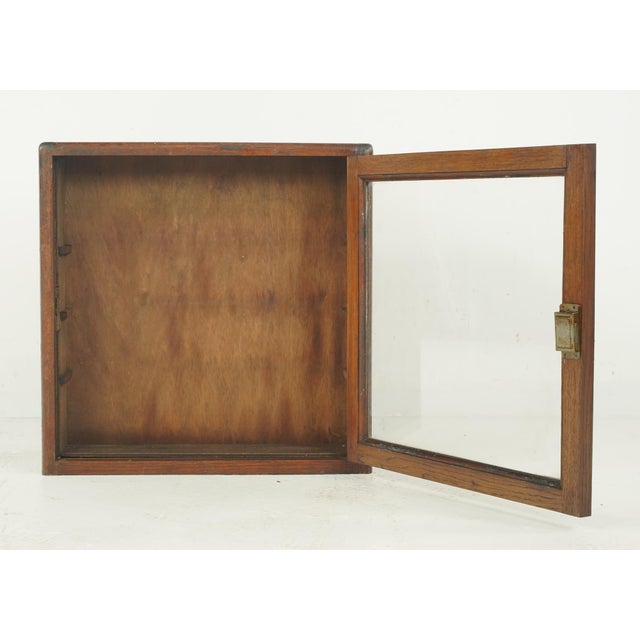 This double sided piece is a vintage industrial shop counter display and storage cabinet, specifically manufactured by...