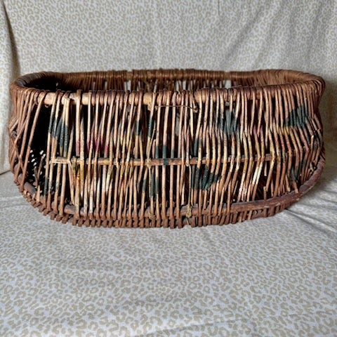 Vintage rustic woven basket constructed from willow with flat reed weaving. The rectangular basket features a slightly...
