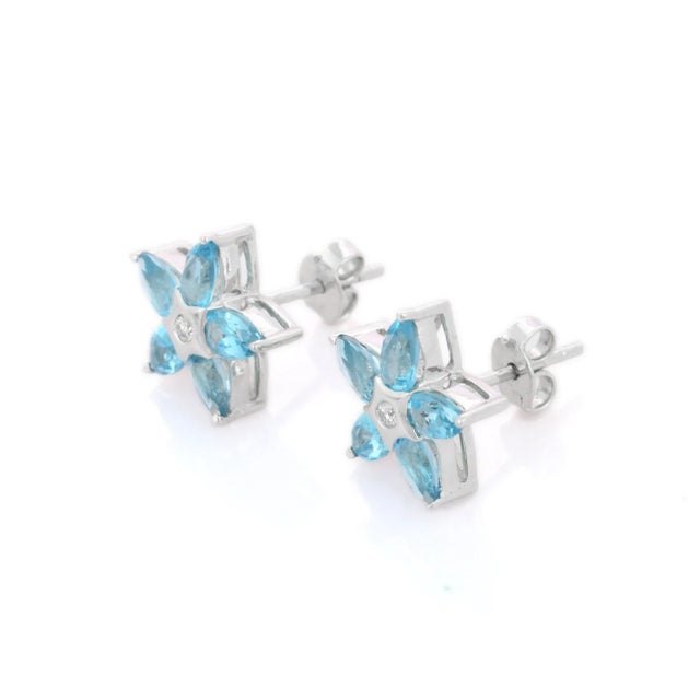 This is part of Chairish’s Fine Jewelry assortment. Indulge in the enchanting allure of these Blue Topaz Pear Cut Flower...