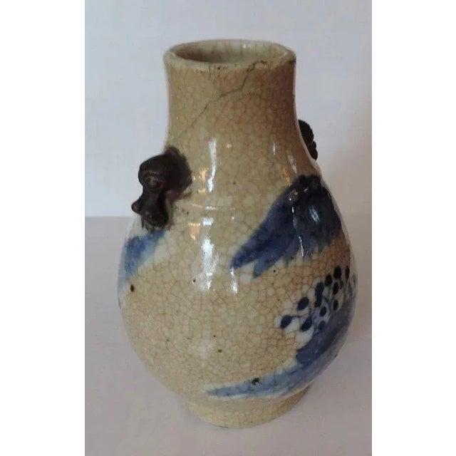 Antique 19th c. Chinese porcelain vase decorated in blue and white on a crackle ground. Brown bisque foo lion mask handles...