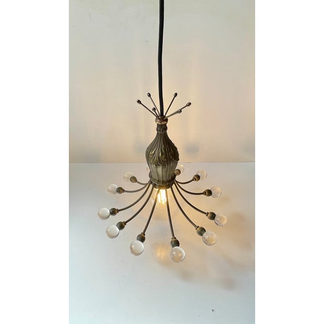 Small unusual pendant chandelier elegantly fashioned from patinated bronze embossed with floral details and set with 12...