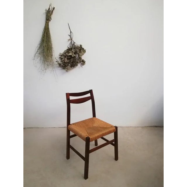 Four chairs made of solid rosewood with hand-woven straw seat. Probably of Italian manufacture but with Scandinavian...