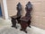 A stunning pair of antique Italian Renaissance walnut hall chairs featuring hand carved shields, stylized shells, and...