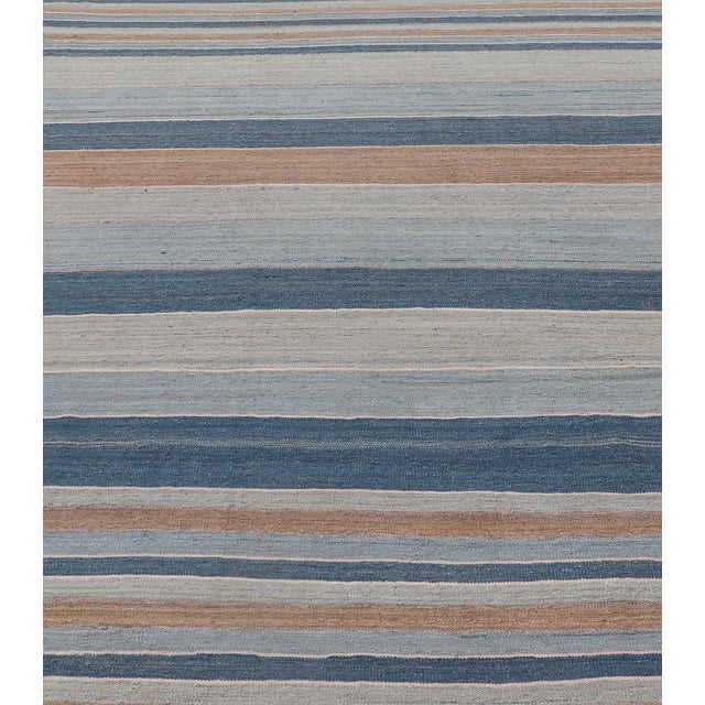Measures: 9'3 x 12. Striped Kilim Blue and Brown Hand Woven Wool By Keivan Woven Arts 9'3 x 12'0 Flat-weave Kilim rug with...
