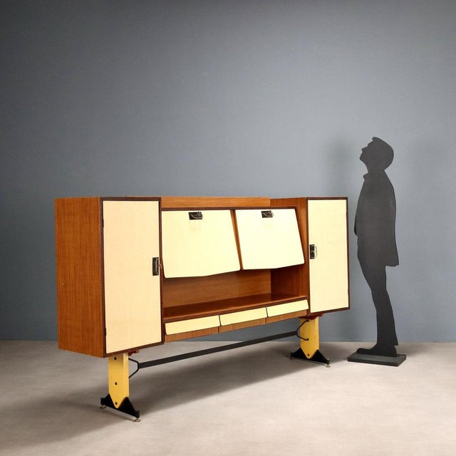 Vintage living room furniture in two-tone laminate with hinged and flap doors, open compartment and lacquered metal...