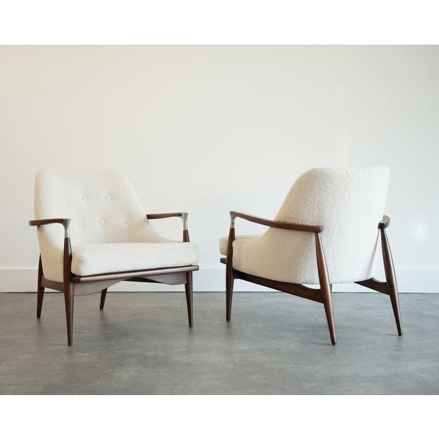 A refined pair of Mid-Century Modern lounge chairs from the 1950s, executed in the style of IB Kofod-Larsen. Though the...