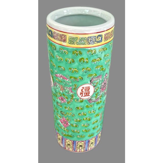 Mun Shou Longevity Umbrella Stand (11¼" H x 4.25" D) A cylindrical porcelain vessel steeped in tradition, featuring the...