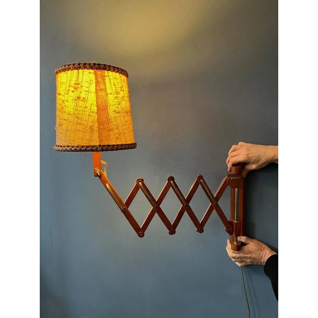 Dutch vintage scissor lamp with cosy, textile shade. The scissor-mechanism is made out of wood and the shade out of...