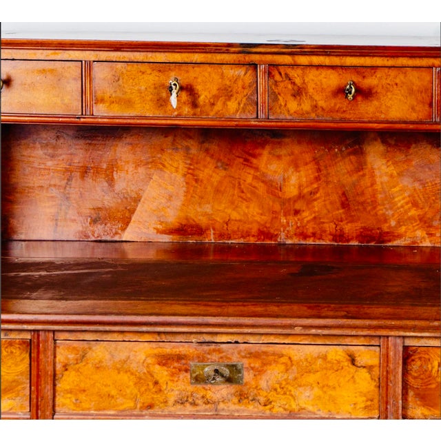 A richly figured and architecturally balanced English Regency Revival burl walnut partner’s desk, dating to approximately...