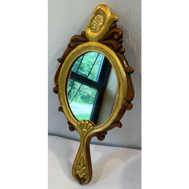 Beautiful Italian gilt wood and walnut hand mirror.