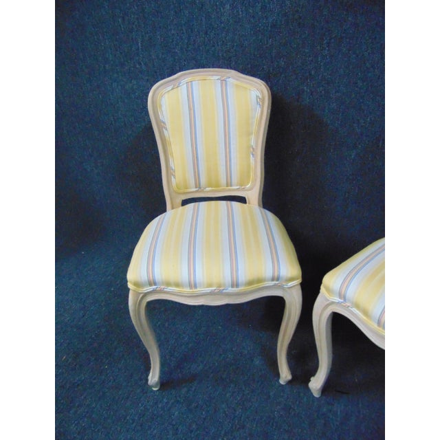 Louis XV style side chairs , made of maple with white stained finish , yellow blue and white stripped fabric