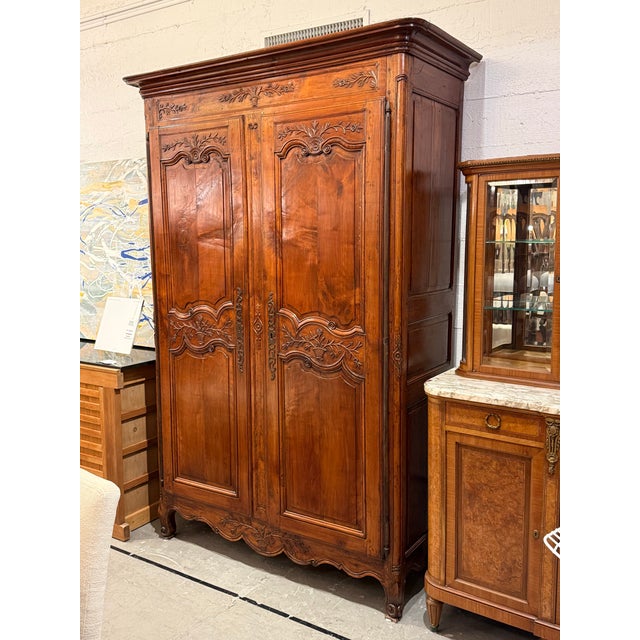 Design Plus Gallery presents a 19th Century French Provincial Carved Walnut Armoire. Constructed from solid woods, this...