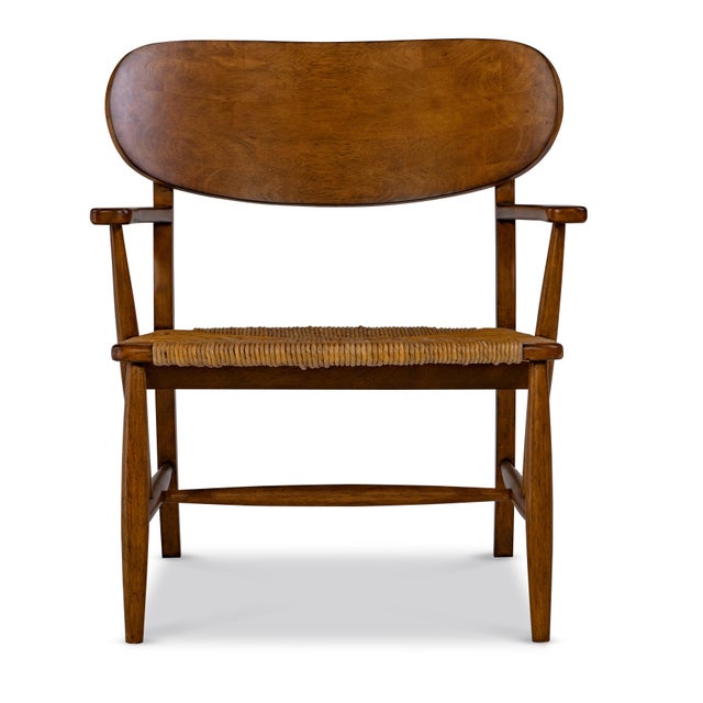 A beautifully proportioned bleached walnut armchair that blends rustic charm with refined craftsmanship. The sculpted wood...